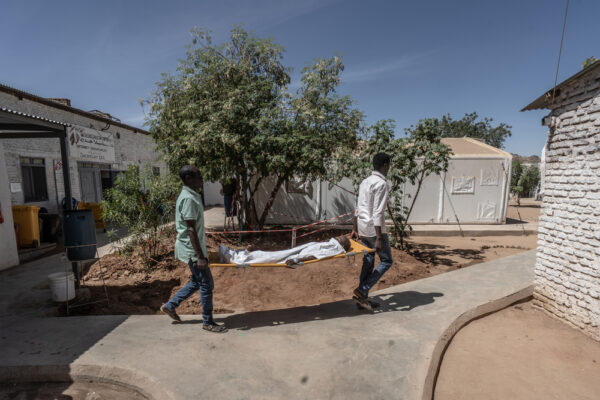 在無國界醫生於塔維拉經營的巴黎醫院，兩名醫護人員將一名男孩從手術室抬上擔架，送往加護病房。這座設施是當地少數仍在運作的醫院之一，服務著數十萬名來自法希爾及週邊地區的流離失所者。照片攝於2026年02月28日。©MSF